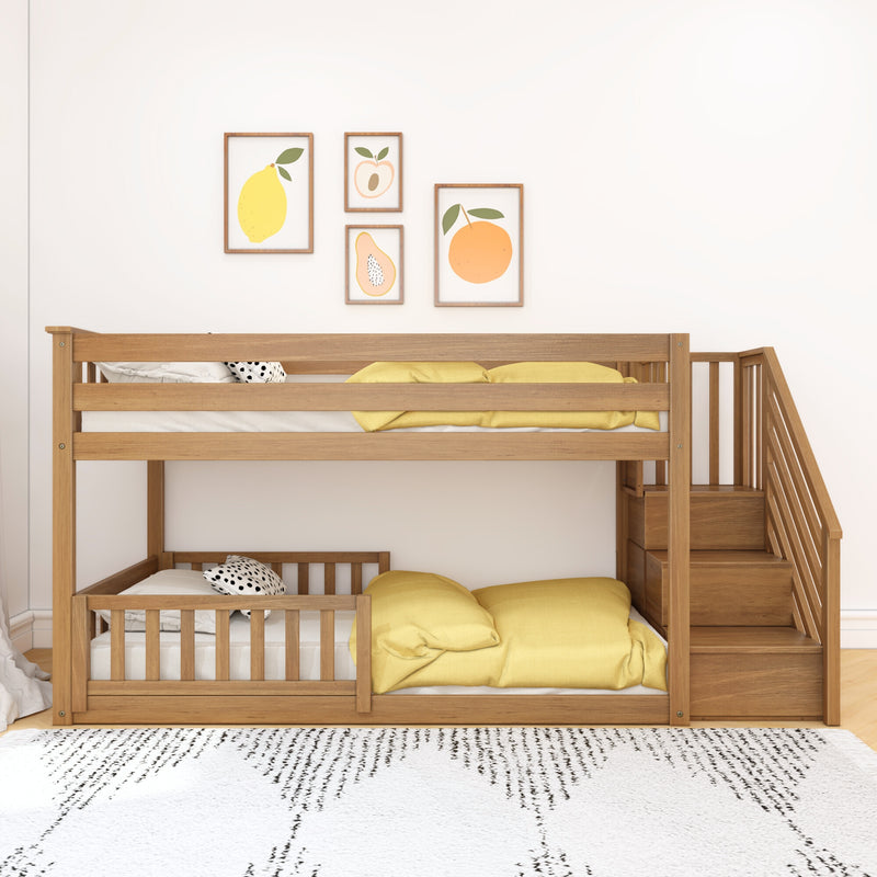 Wooden bunk bed with built-in stairs and storage, yellow bedding and fruit wall art in a modern children's bedroom