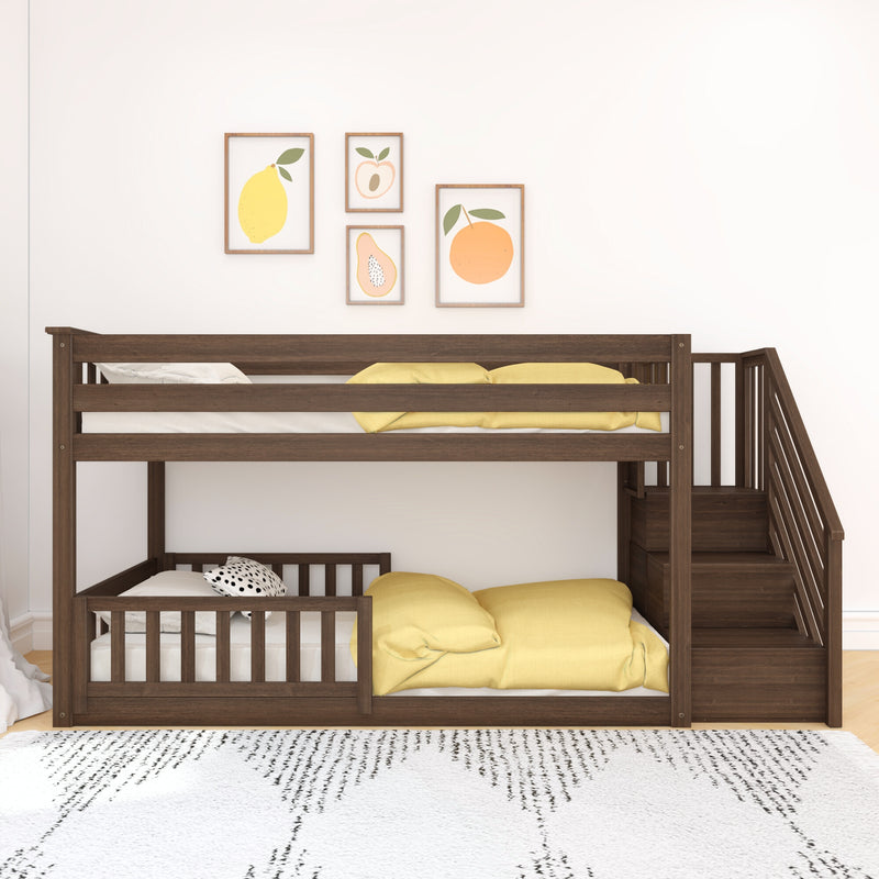 Dark brown solid wood bunk bed with built-in staircase and storage, styled with yellow bedding and fruit-print wall art in a modern kids' bedroom