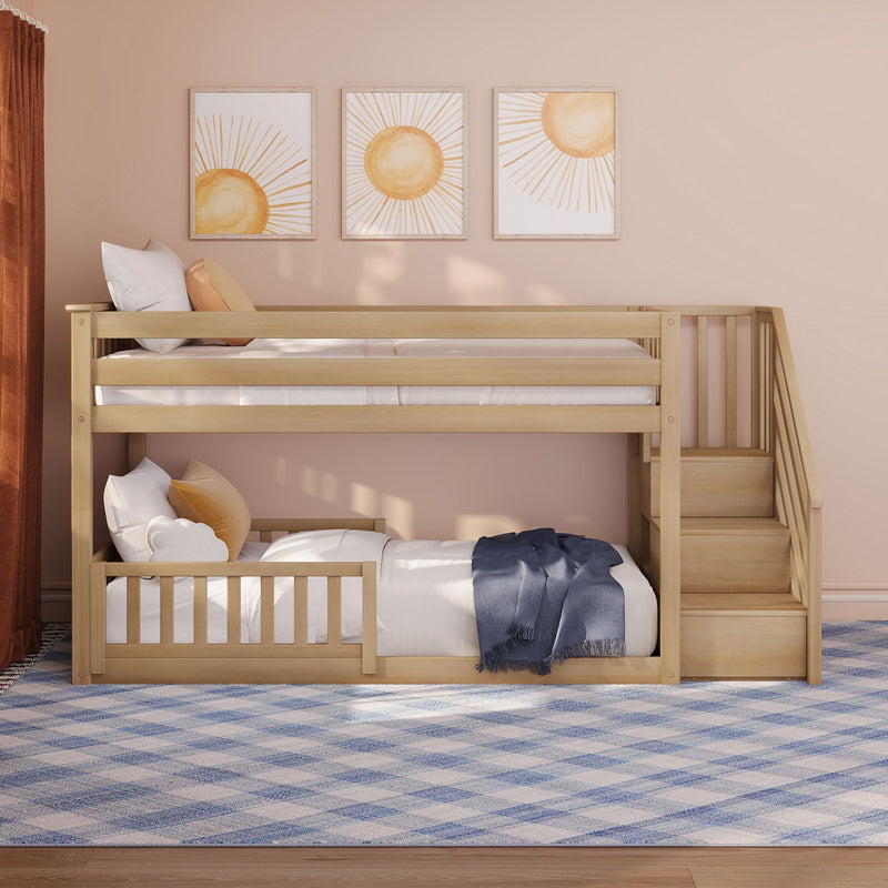 Natural wood twin-over-twin bunk bed with stairs in blush-pink nursery, sun wall art and cozy pillows