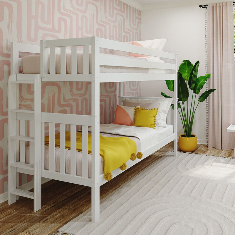 White twin bunk bed in modern kids' bedroom with pink geometric wallpaper, yellow pom-pom throw and accent pillows, potted tropical plant, blush curtains and neutral rug