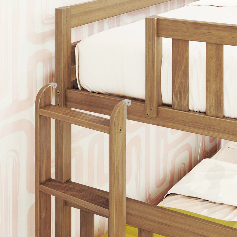 Close-up of solid wood bunk bed safety rail and ladder with white bedding and pastel pink abstract wallpaper in a children's nursery
