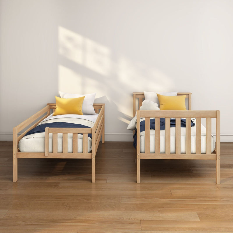 Twin wooden beds in a modern minimalist kids' bedroom with white bedding, yellow accent pillows, natural sunlight casting window shadows on a neutral wall and warm hardwood floors