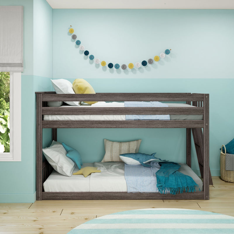 Wooden kids bunk bed in a turquoise coastal children's bedroom with striped bedding, star and whale pillows and pom-pom garland wall decor