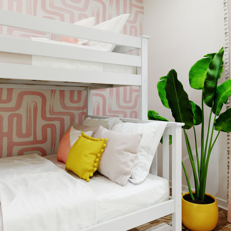 White bunk bed in modern kids bedroom with pink geometric wallpaper, yellow pom-pom accent pillow and potted tropical plant