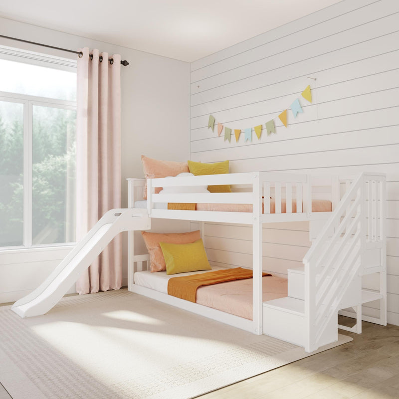 White wooden bunk bed with slide in bright modern kids’ bedroom, pastel pillows, shiplap wall and colorful bunting