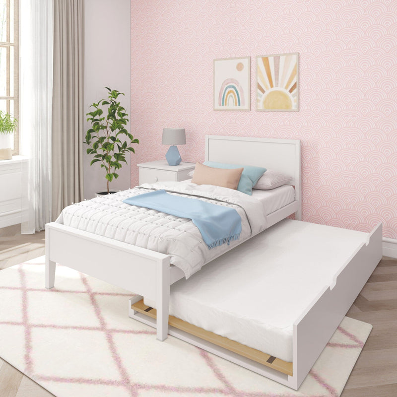 Girls' bedroom with pink scallop wallpaper, white trundle bed, pastel bedding and pillows, blue throw, rainbow wall art, bedside lamp and potted plant