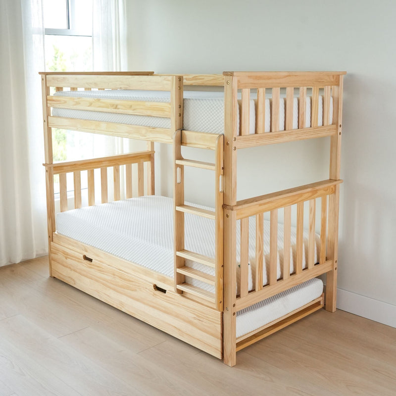 Natural pine twin-over-twin bunk bed with ladder and pull-out trundle, white mattresses and sheer curtains in a bright minimalist kids bedroom