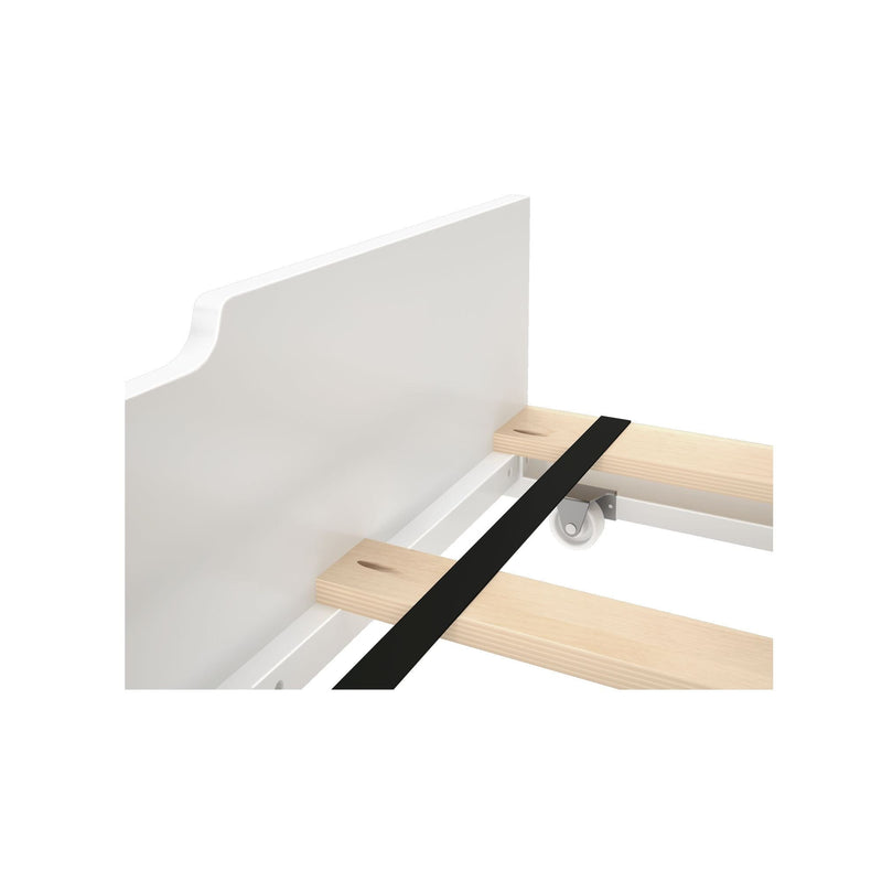 Close-up of white bed frame slatted base with pine wooden slats, black center support strap and caster wheel