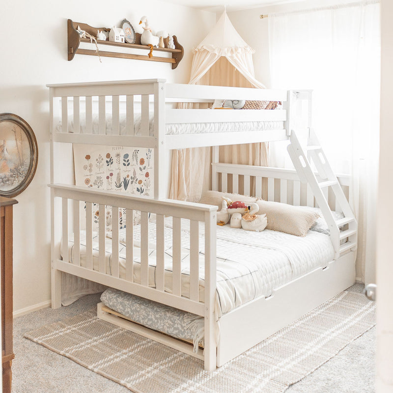 White wooden bunk bed with ladder and canopy in a neutral boho nursery, cozy bedding, stuffed toys and botanical wall art