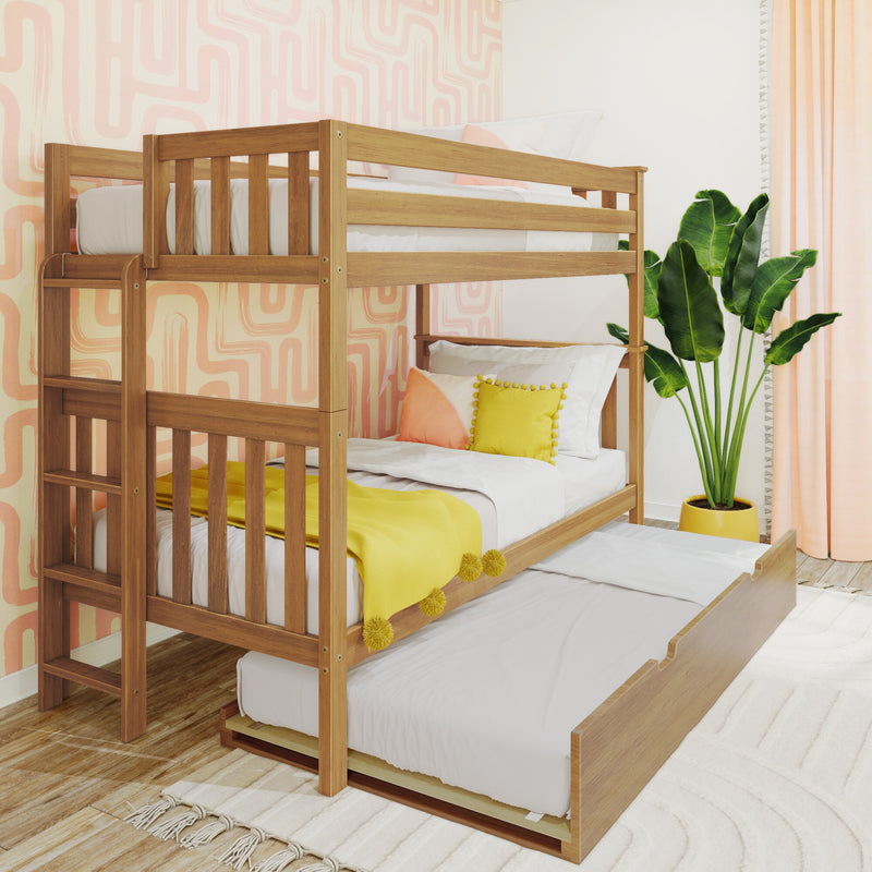 Wooden bunk bed with pull-out trundle in a bright kids' bedroom featuring pink geometric wallpaper, yellow pillows and a tropical potted plant