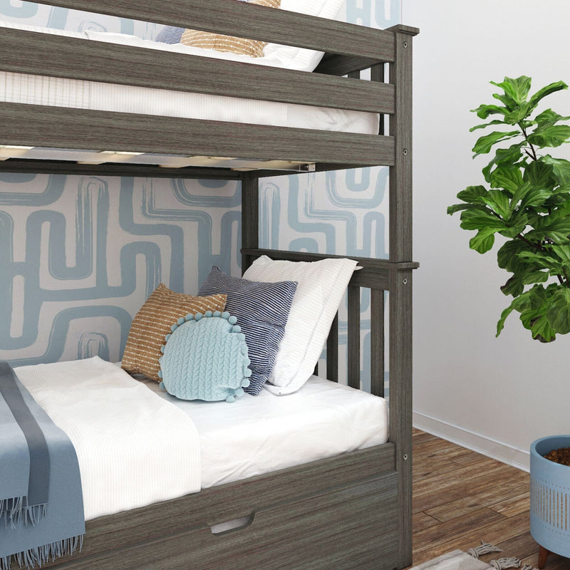 Gray wood twin bunk bed with under-bed storage drawer, white bedding, blue throw and decorative pillows against blue geometric wallpaper in a modern kids' bedroom with fiddle-leaf plant