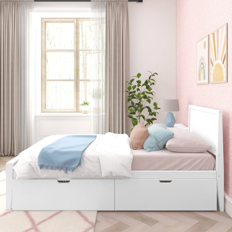 Sunlit pastel pink kids' bedroom with white storage bed, layered white and blush bedding and blue throw, decorative rainbow and sun wall art, potted plant, sheer curtains and wood-framed window