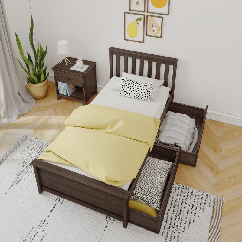 Wooden twin storage bed with yellow duvet, under-bed drawers, polka-dot pillow, nightstand lamp, potted plant and fruit wall art