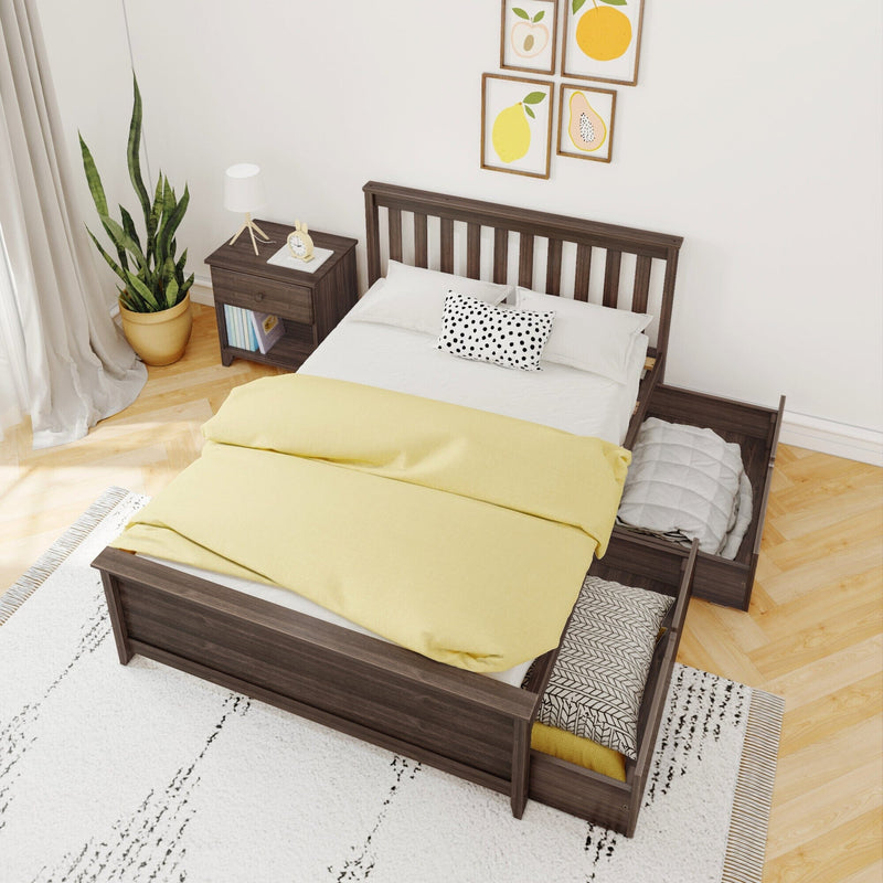 Modern Scandinavian bedroom featuring a dark wood platform bed with pull-out trundle, yellow duvet, polka-dot pillow, wooden nightstand, potted snake plant and framed fruit prints