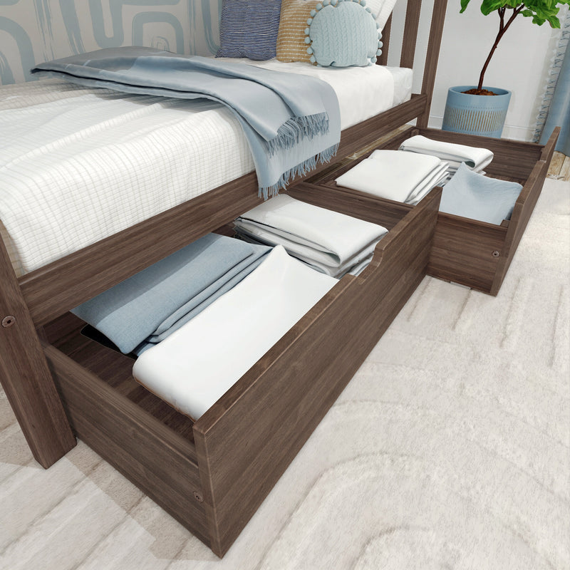Under-bed storage drawers in wooden platform bed with neatly folded linens, light blue throw and decorative pillows — space-saving bedroom storage solution