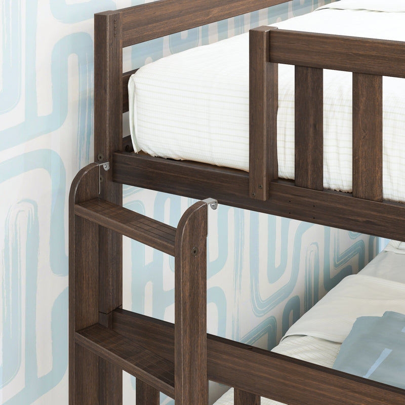 Close-up of kids' dark walnut solid wood bunk bed ladder and safety guardrail with white striped bedding and blue geometric wallpaper