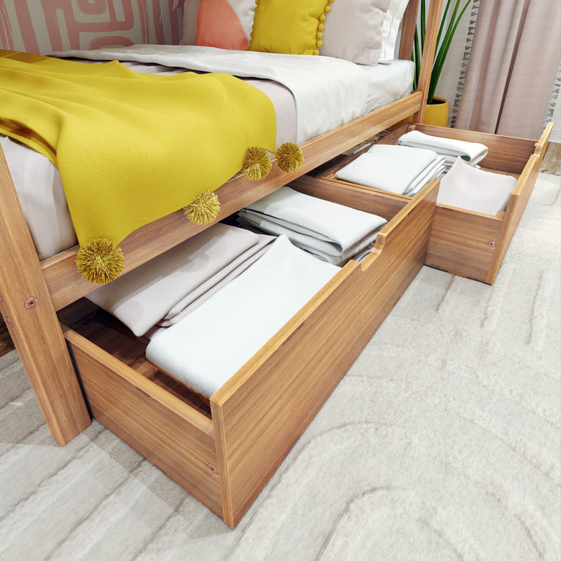 Wooden platform bed with under-bed storage drawers open, yellow throw blanket and neatly folded linens — space-saving bedroom storage solution
