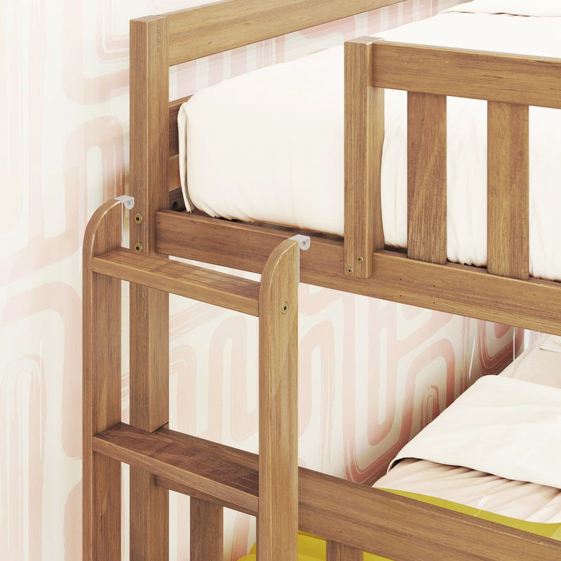 Solid wood children's bunk bed with safety rails and ladder, oak finish, white bedding, pink nursery wallpaper