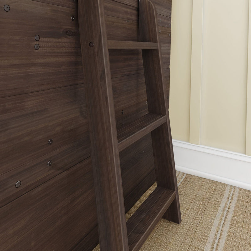 Walnut wooden ladder attached to a dark wood-paneled bed frame next to a beige wall and woven jute rug, modern bedroom detail