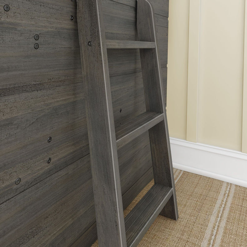 Gray wooden ladder leaning against dark wood plank accent wall beside beige wall and jute rug, rustic loft ladder