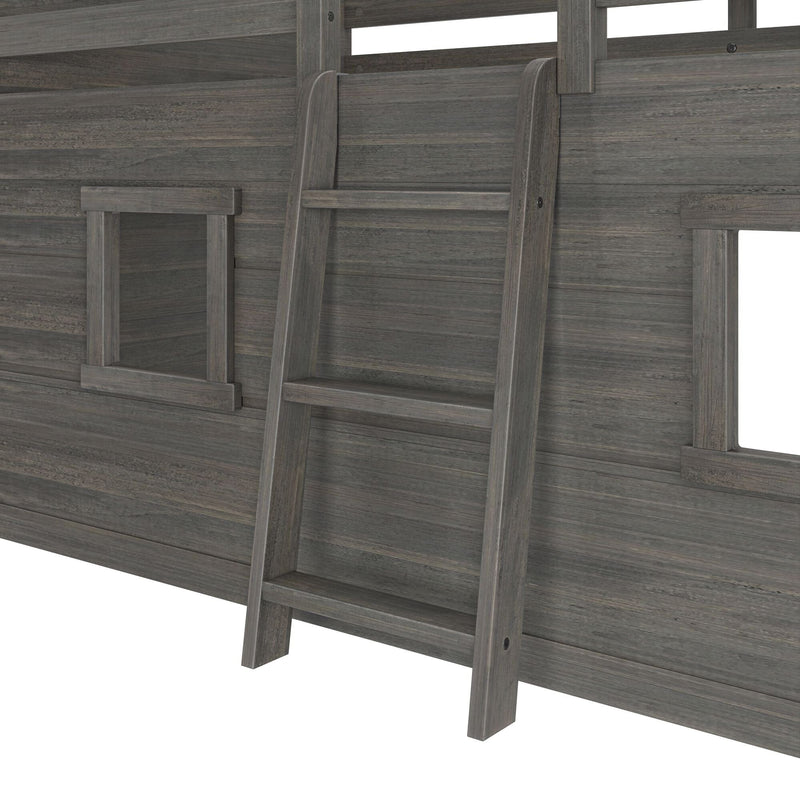 Close-up of gray wooden ladder against rustic gray wood-paneled wall with small window openings, loft bed or kids playhouse ladder detail