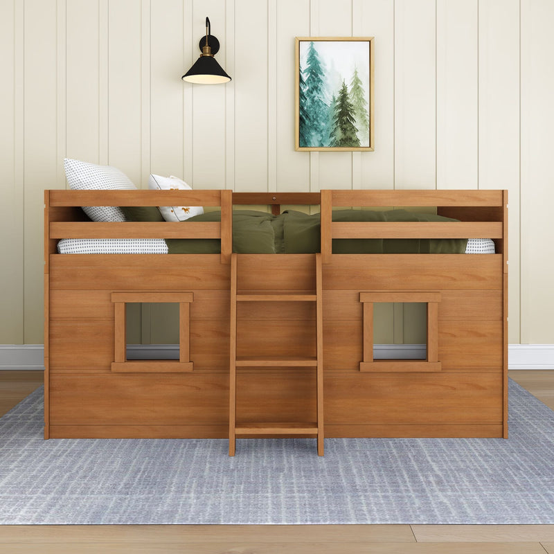 Modern wooden twin bunk bed with olive green bedding, patterned pillows, framed pine tree wall art and black wall sconce against neutral shiplap kids' bedroom wall