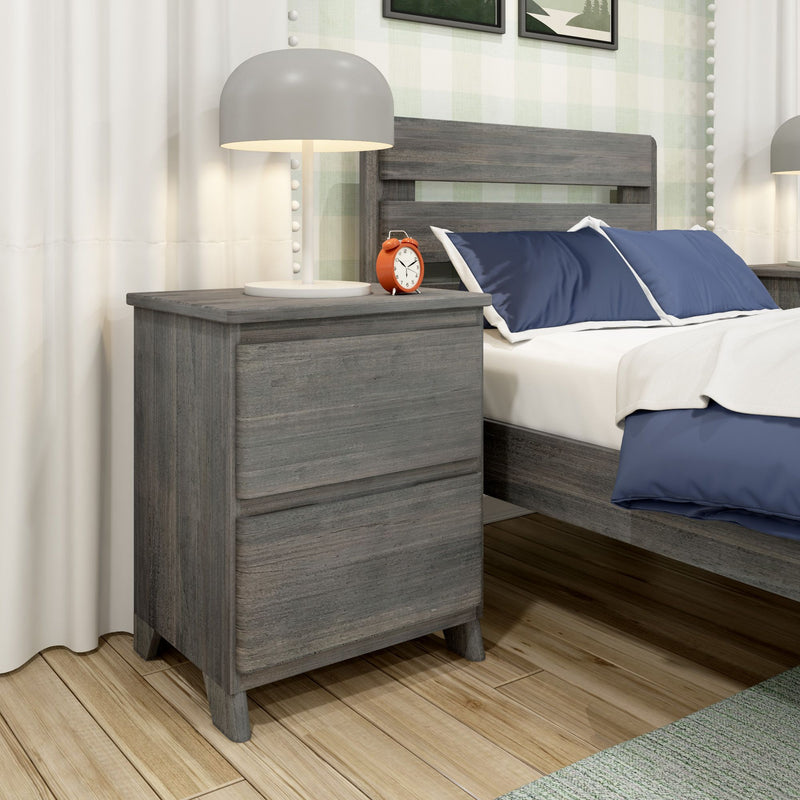 Modern gray wood nightstand with white table lamp and orange alarm clock beside bed with navy pillows and white bedding in a contemporary bedroom with hardwood floor