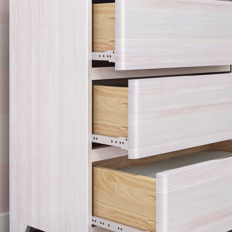 Close-up of modern whitewashed wooden dresser with partially open drawers revealing plywood interiors and metal drawer slides, bedroom storage furniture