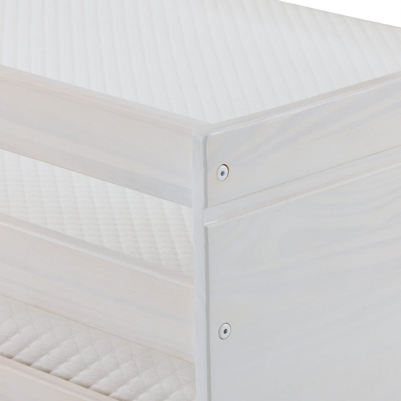 Close-up of white painted wooden bed frame corner showing a metal screw and quilted mattress surface — minimalist bedroom furniture detail