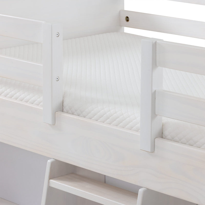 Close-up of white wooden bunk bed frame with safety guardrails, ladder steps, and white quilted mattress
