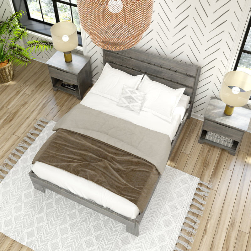 Overhead view of a modern farmhouse bedroom with gray wood bed, white bedding and beige throw, nightstands with lamps, woven pendant, herringbone accent wallpaper, wood plank flooring and potted palm