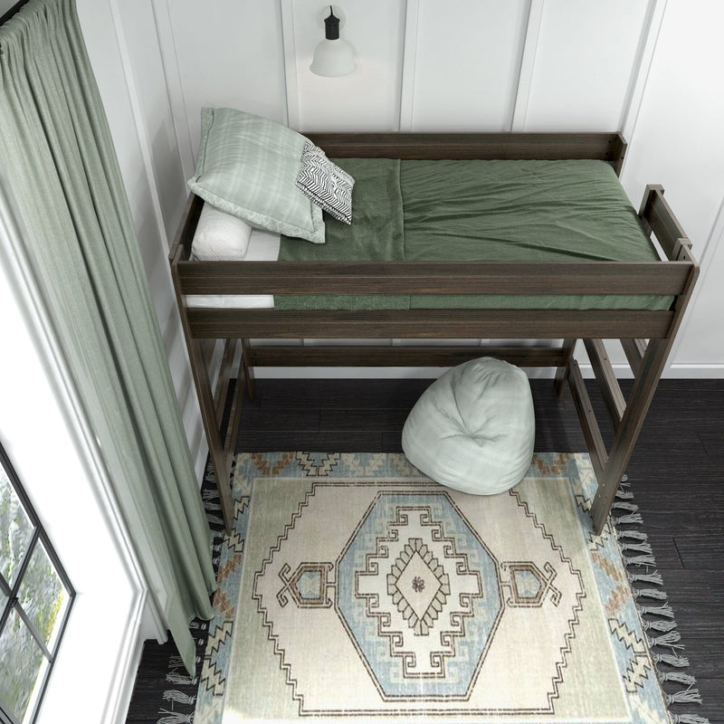Wooden loft bed with green bedding, mint curtains, patterned boho rug and bean bag in modern kids bedroom