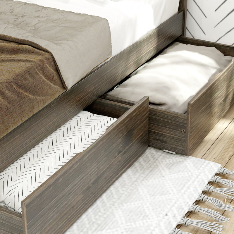 Close-up of a wooden platform storage bed with pull-out underbed drawers and neutral linen bedding