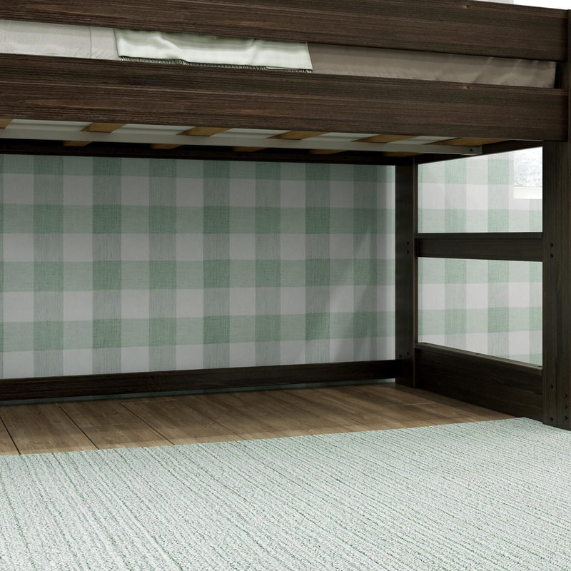 Dark wood bunk bed frame with ladder and slatted mattress support against green plaid wallpaper in a kids' bedroom with hardwood floor and light textured rug