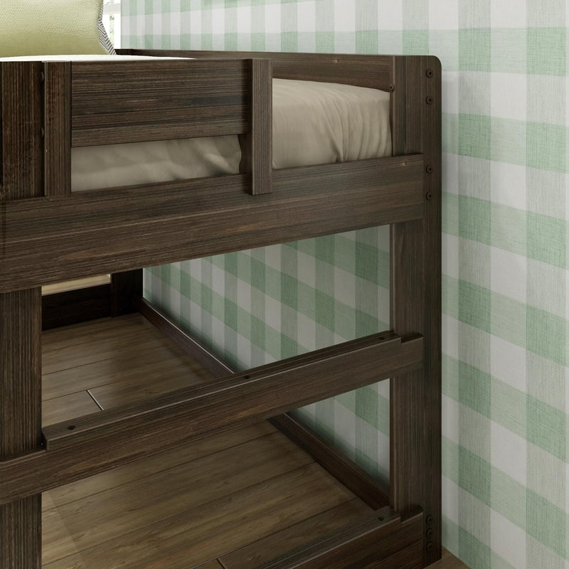 Close-up of dark wood bunk bed frame with guard rails, beige mattress and green plaid wallpaper in a children's bedroom