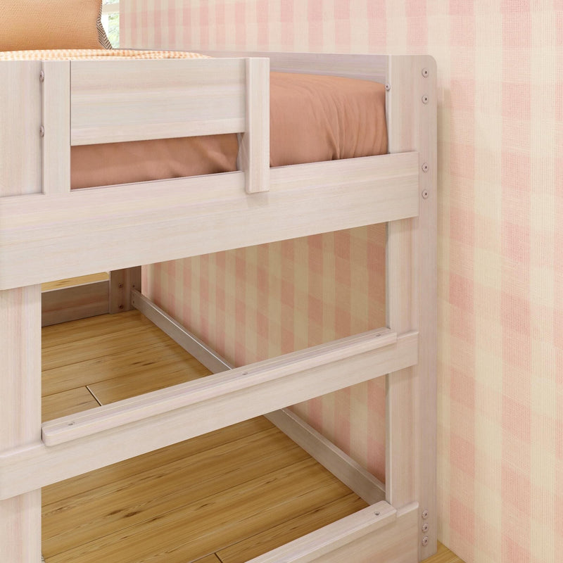 Light wood bunk bed frame with safety side rail, peach bedding, checkered pink wallpaper and hardwood floor in a modern kids' bedroom