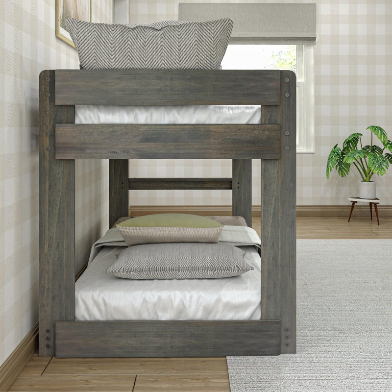 Rustic gray twin-over-twin wooden bunk bed with neutral textured pillows in a cozy plaid wallpaper bedroom with a potted plant