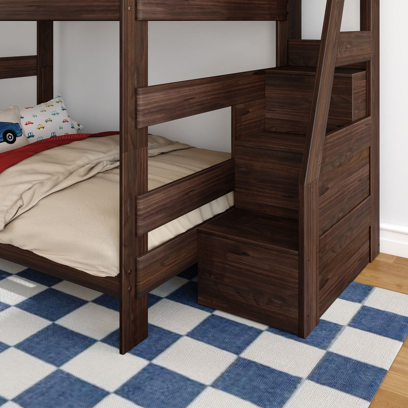 Dark walnut-finish wooden bunk bed with built-in staircase storage, beige bedding and car-patterned pillow in a children's bedroom on a blue checkered rug