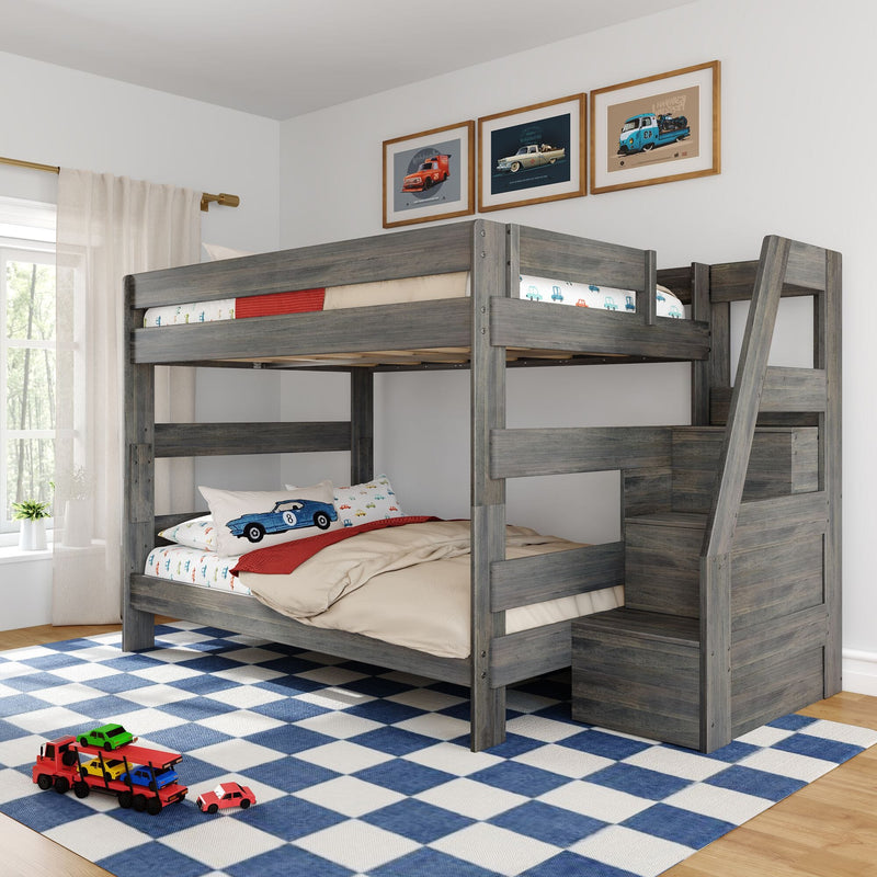 Gray wooden loft bunk bed with ladder and storage stairs in kids' bedroom, car-themed bedding and pillows, framed car prints, blue checkered rug and toy cars