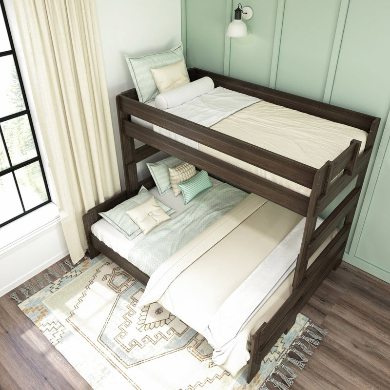 Dark wood twin-over-twin bunk bed in a mint green kids' bedroom with cream curtains, layered neutral bedding, decorative pillows, wall sconce, and patterned area rug