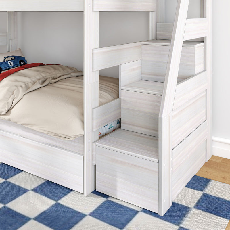 White wooden bunk bed with built-in storage stairs and drawers, beige bedding and car-themed pillow on lower bunk in a kids' room with blue checkered rug