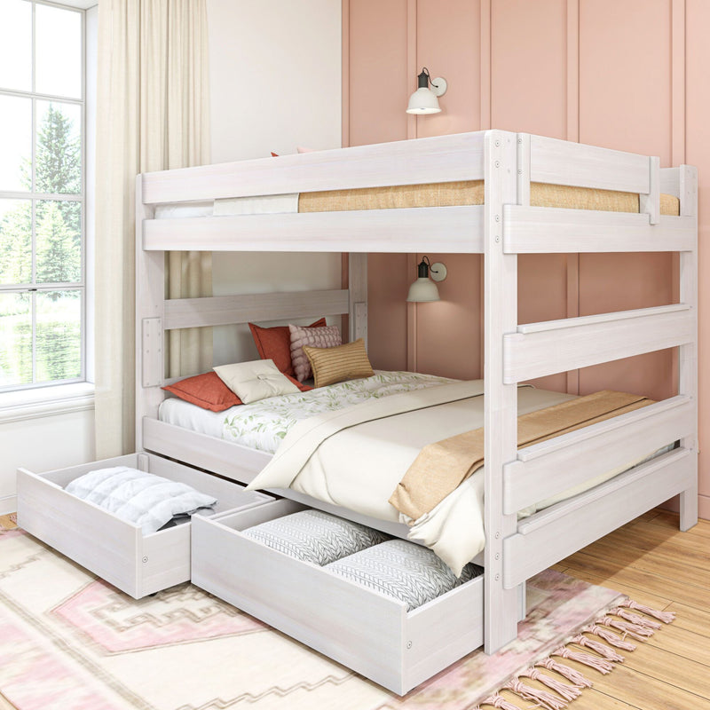 White wooden bunk bed with pull-out trundle and storage drawers in a bright bedroom with blush pink accent wall, wall sconces and decorative pillows