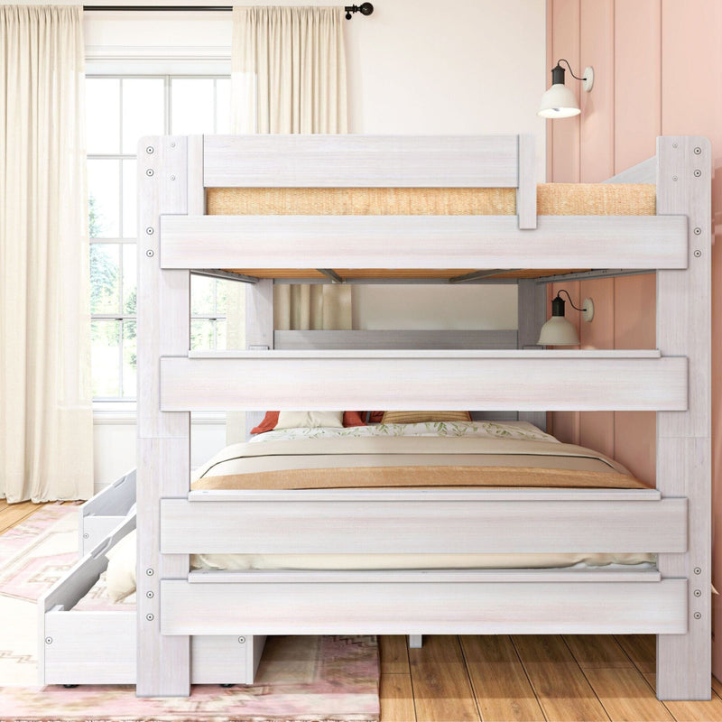 Whitewashed wooden bunk bed with pull-out trundle and storage drawers, neutral bedding and wall sconce in a light-filled kids' bedroom with curtains