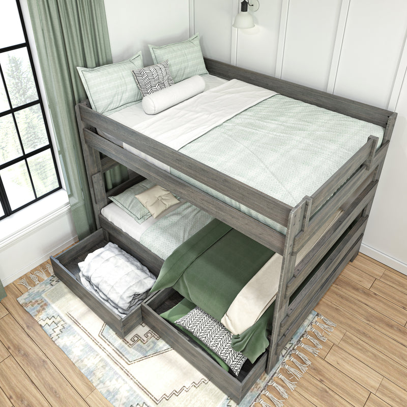 Gray wooden twin-over-twin bunk bed with pull-out under-bed storage drawers, green bedding and patterned pillows in a sunlit modern farmhouse bedroom