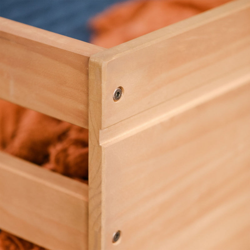 Close-up of solid maple bed frame corner with recessed screw and smooth natural wood finish on modern platform bed