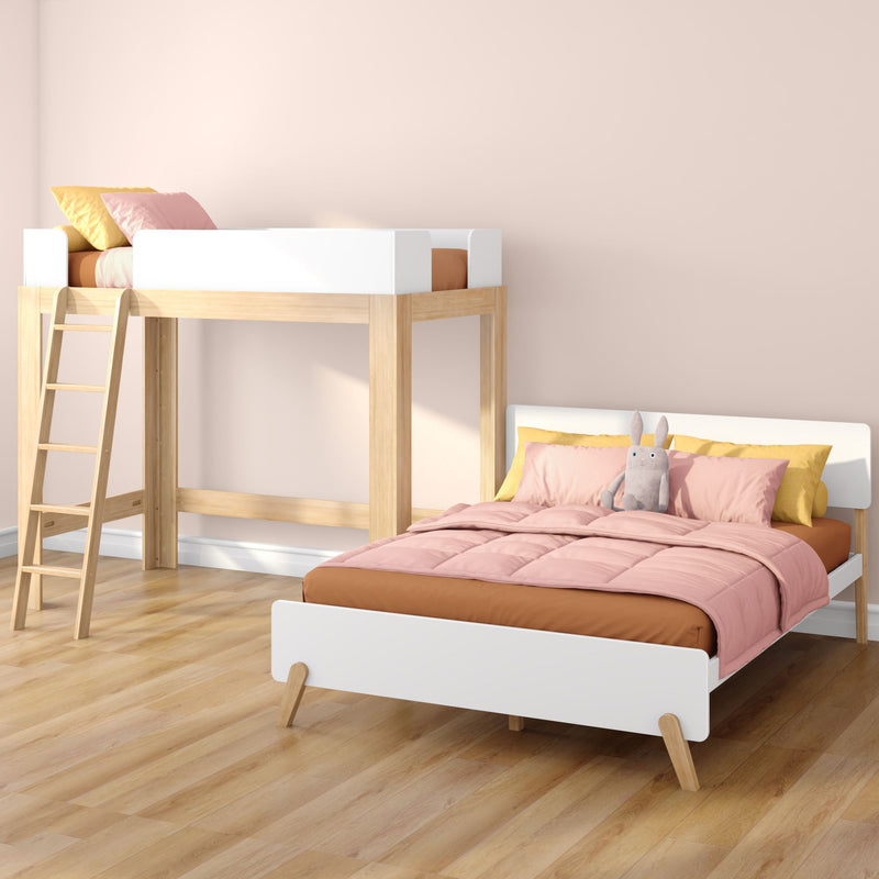 Modern wooden kids loft bunk bed with pink comforter, yellow pillows and plush rabbit in pastel nursery