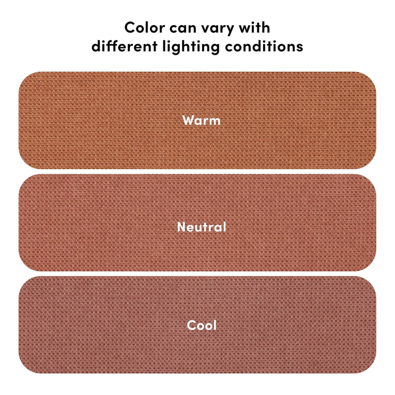 Rust-colored woven fabric color swatches labeled Warm, Neutral, Cool with visible texture and the note “Color can vary with different lighting conditions” illustrating lighting effects on hue