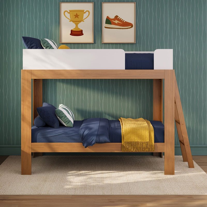 Wooden bunk bed with navy bedding and striped green wallpaper, decorative pillows, framed trophy and sneaker prints, and a yellow throw in a modern kids' bedroom