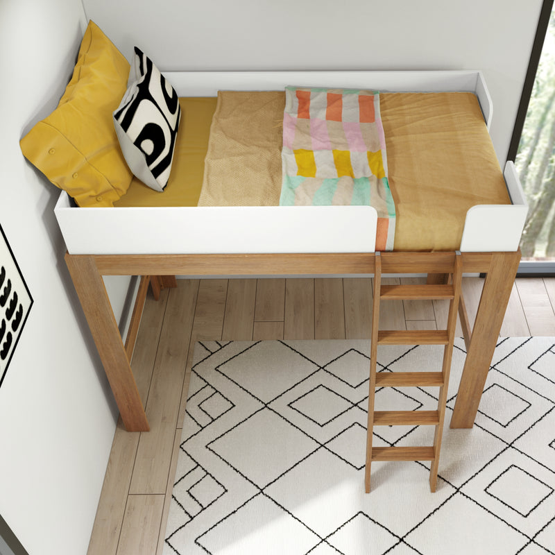 Top-down view of a modern wooden loft bed with white guardrail, mustard-yellow bedding, black-and-white patterned pillow, pastel multicolor throw and wooden ladder over a geometric rug