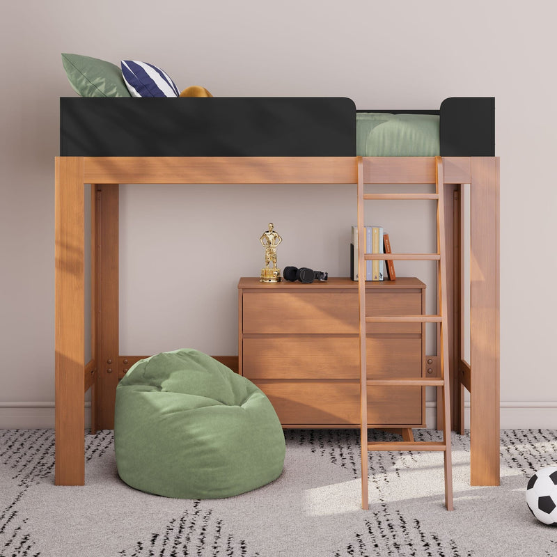 Wooden loft bed with ladder and black safety rail above a dresser, green bean bag, books, headphones and trophy in modern kids' bedroom